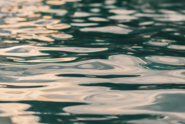 Sunlit ripples on water signifying Jesus' baptism