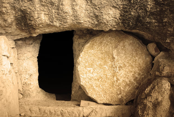 An old stone tomb with the stone rolled away.