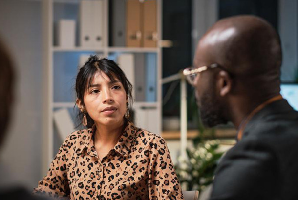 Woman and man from different nations joining in a serious discussion