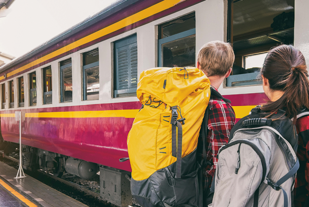 Two backpackers waiting racing for a train