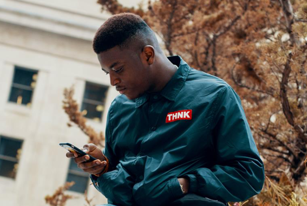 Man sitting outside looking at his phone
