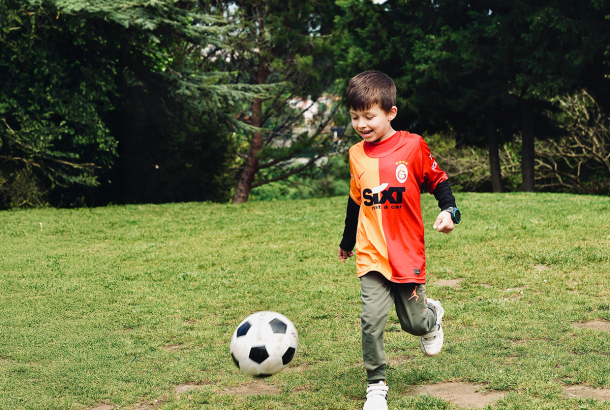 boy kicking a football