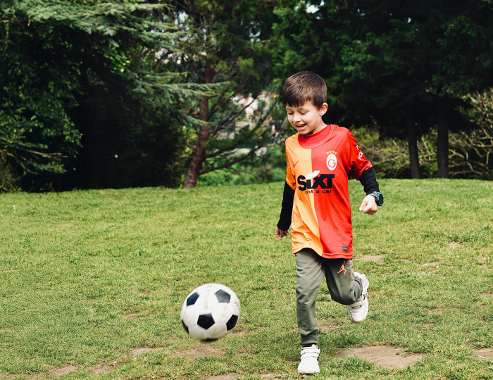 boy kicking a football