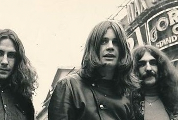 Black and white image of young Ozzy Osbourne and band mates.